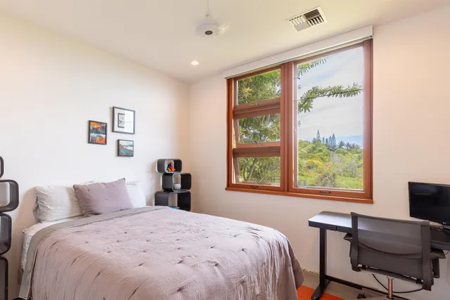a bedroom with a large bed and a window