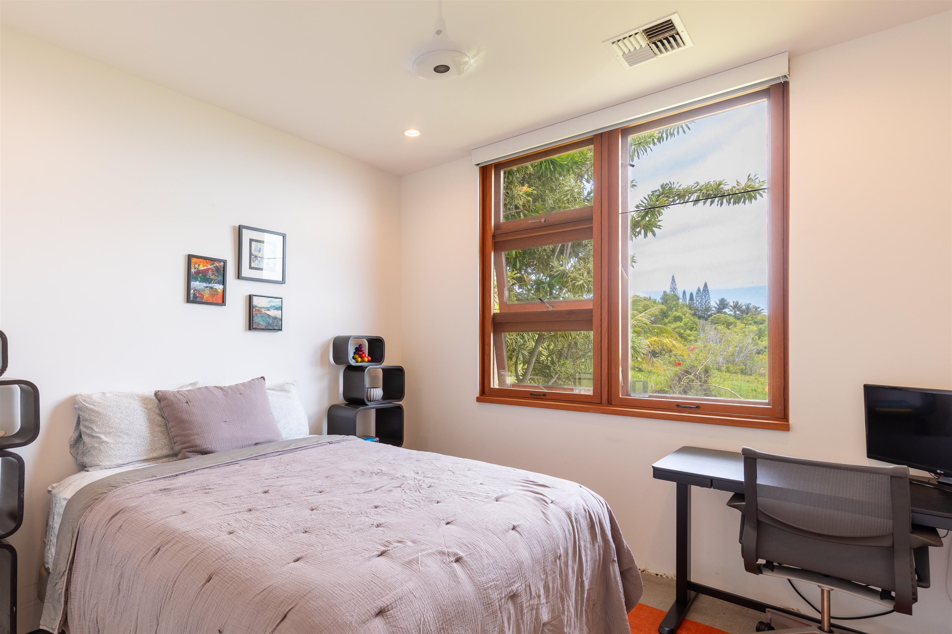 454 Hoolawa Road Haiku, HI 96708 - Photo 27 of 43 a bedroom with a large bed and a window