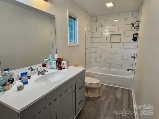 a bathroom with a sink toilet tub and shower