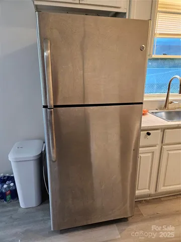 a white refrigerator freezer sitting in a kitchen