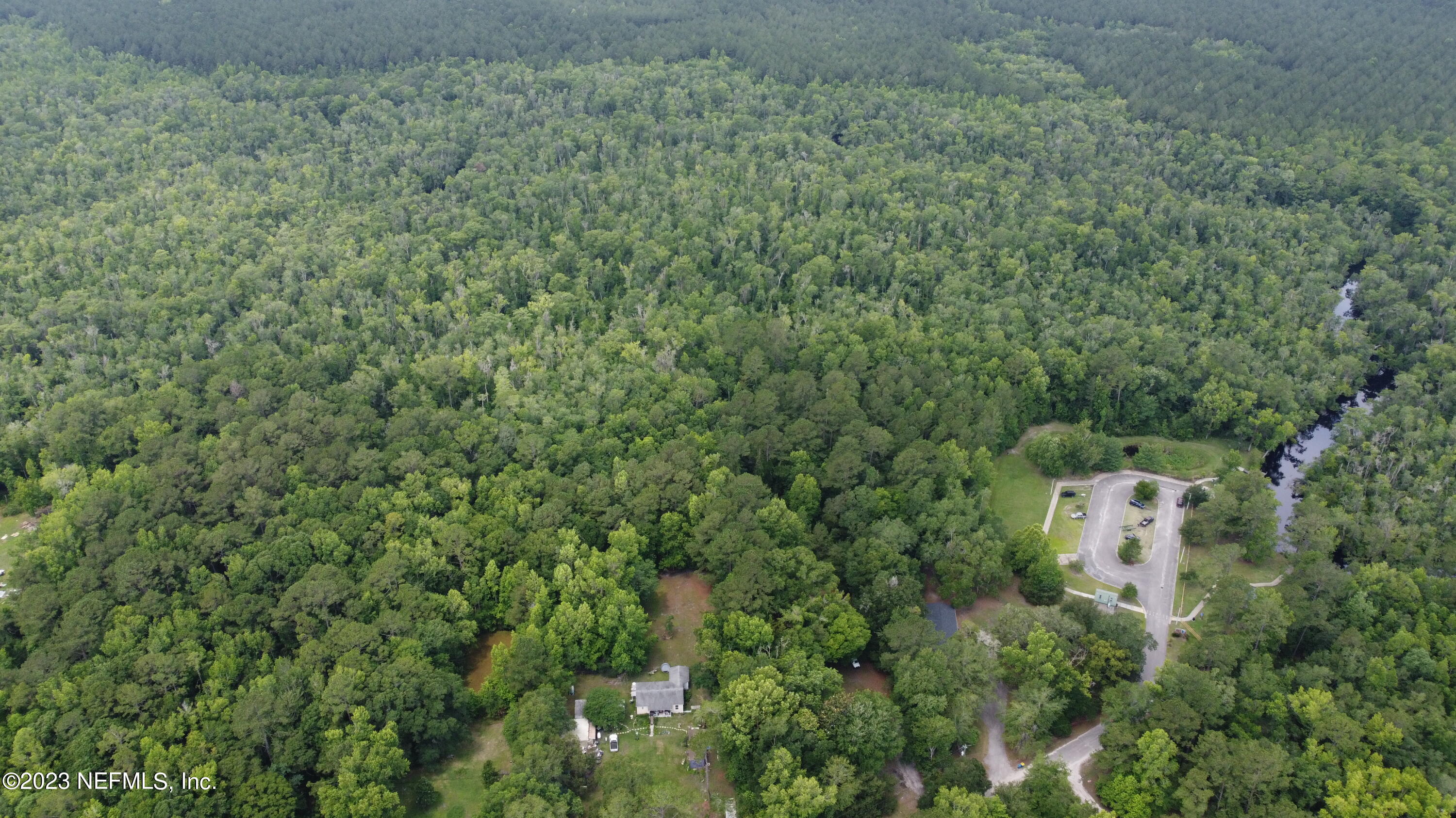 0 Ethel Road Jacksonville, FL 32218 - Photo 2 of 24 an aerial view of a house with a yard and trees all around