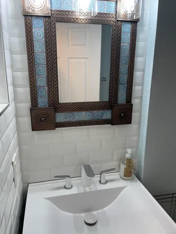 a bathroom with a sink and a mirror