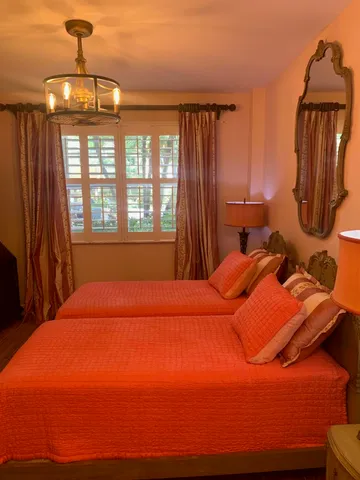 a bed room with a bed window and dresser