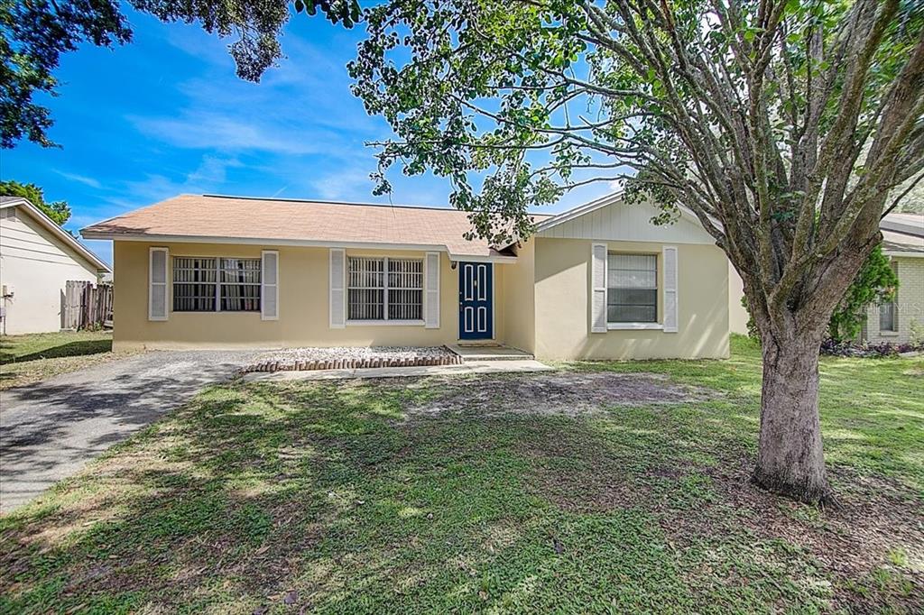 a house that has a tree in front of a house