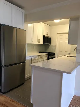 a kitchen with stainless steel appliances a refrigerator sink and microwave