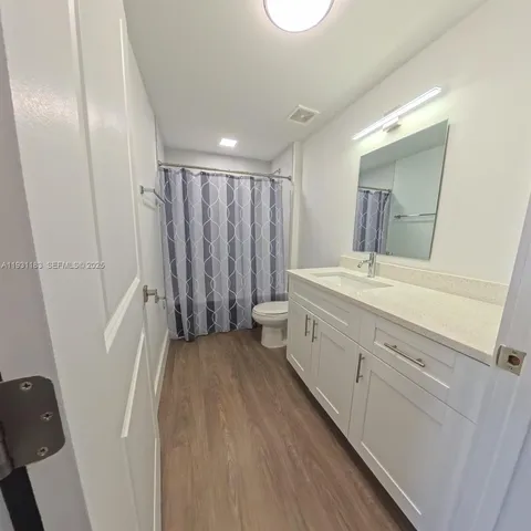 a bathroom with a double vanity sink and mirror