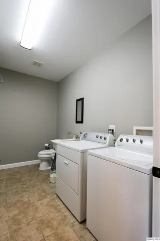 a room with a sink and a washer dryer