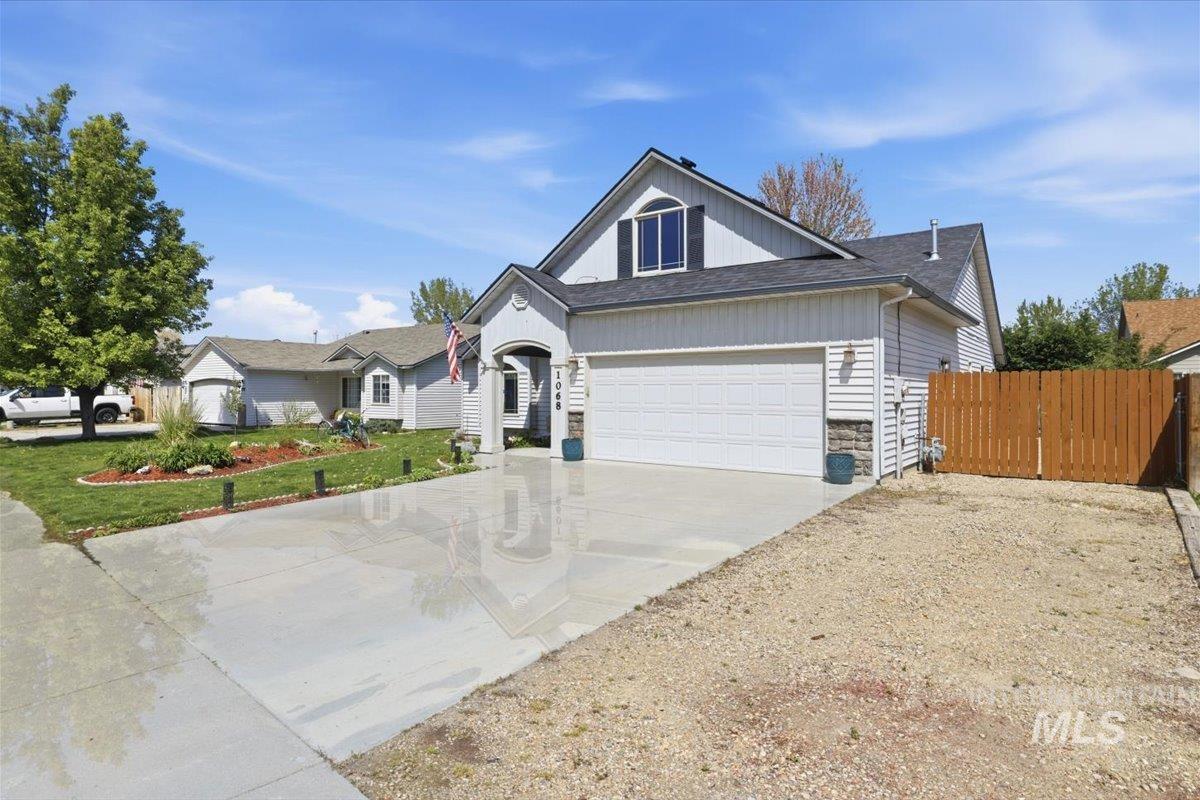 1068 Locksley Street Middleton, ID 83644 - Photo 2 of 30 Contemporary two-story residence with a two-car garage, partial stone facade, and a light-colored siding exterior