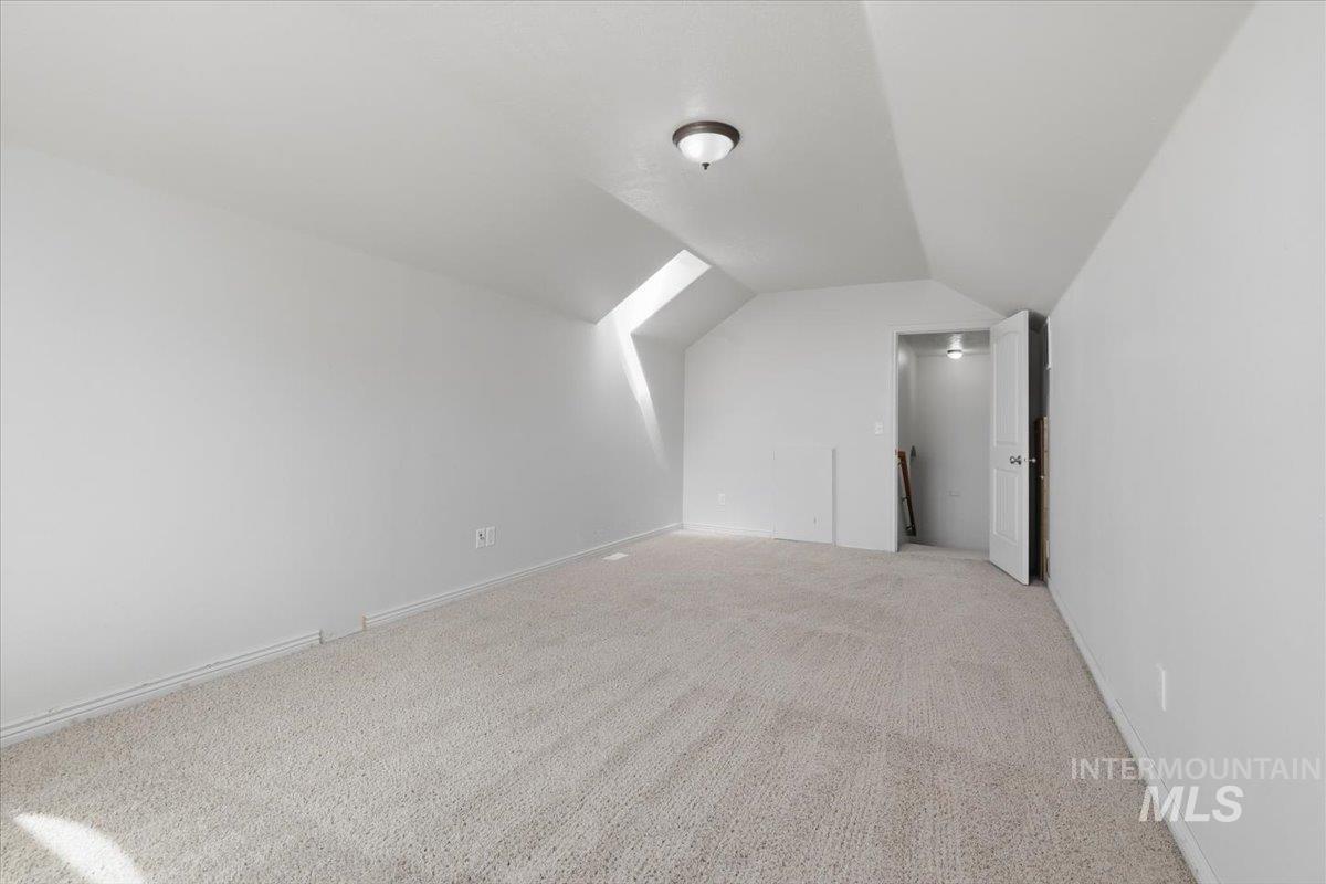 1068 Locksley Street Middleton, ID 83644 - Photo 23 of 30 Versatile room featuring light-toned carpet flooring, white walls, and a sloped ceiling design