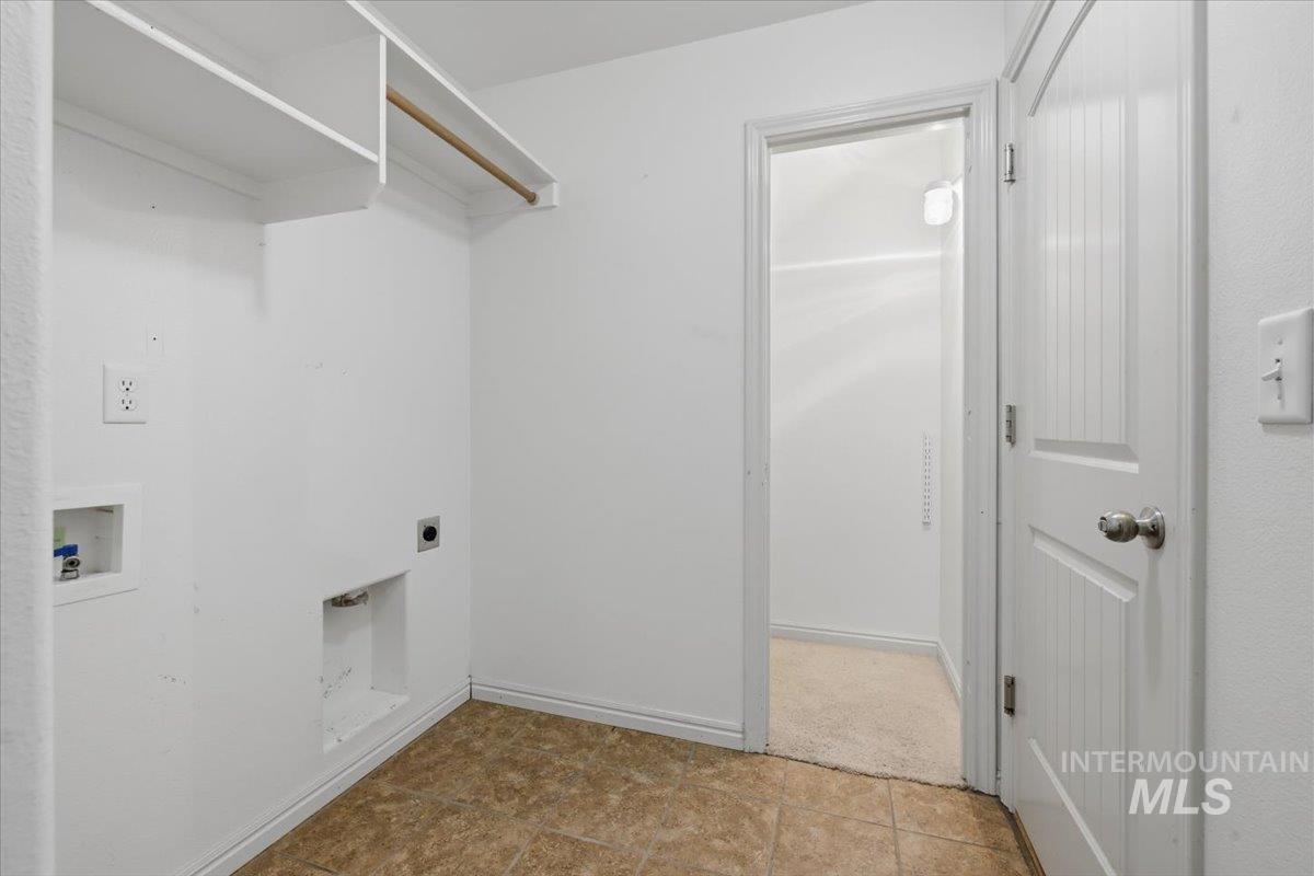 1068 Locksley Street Middleton, ID 83644 - Photo 24 of 30 Utility area featuring a laundry hookup, overhead shelving, and a hanging rod