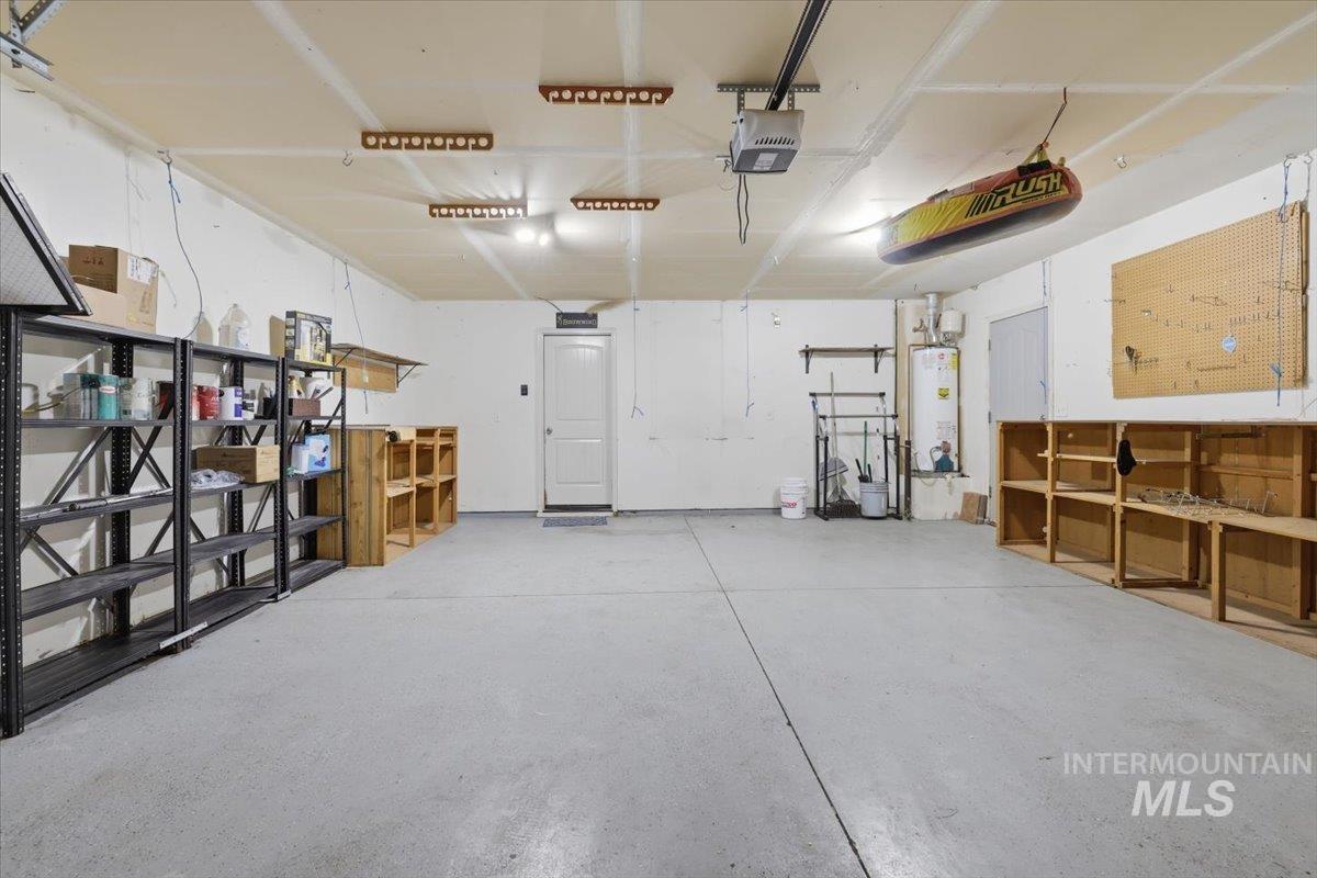1068 Locksley Street Middleton, ID 83644 - Photo 25 of 30 Spacious garage featuring a concrete floor, built-in shelving, and overhead lighting