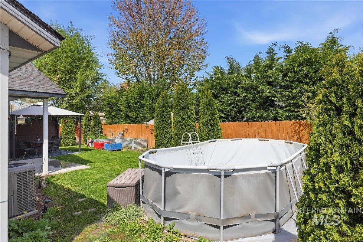 1068 Locksley Street Middleton, ID 83644 - Photo 29 of 30 Expansive backyard featuring a lush lawn, mature perimeter trees, and a wooden privacy fence