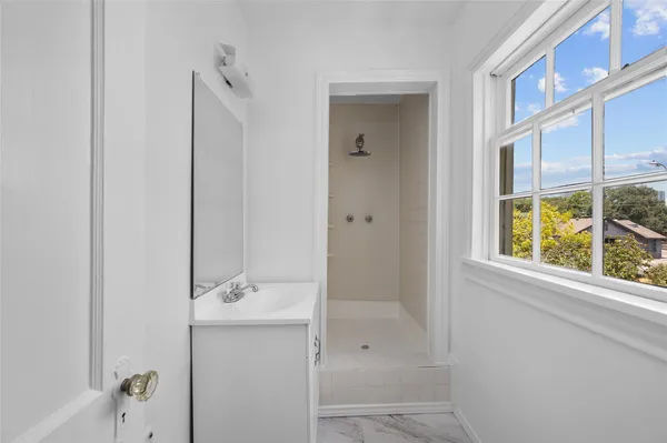 a bathroom with a shower and a sink