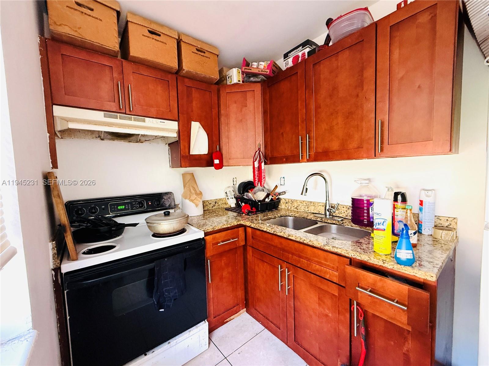 635 Northwest 22nd Road Fort Lauderdale, FL 33311 - Photo 18 of 20 a kitchen with stainless steel appliances granite countertop a sink stove and cabinets