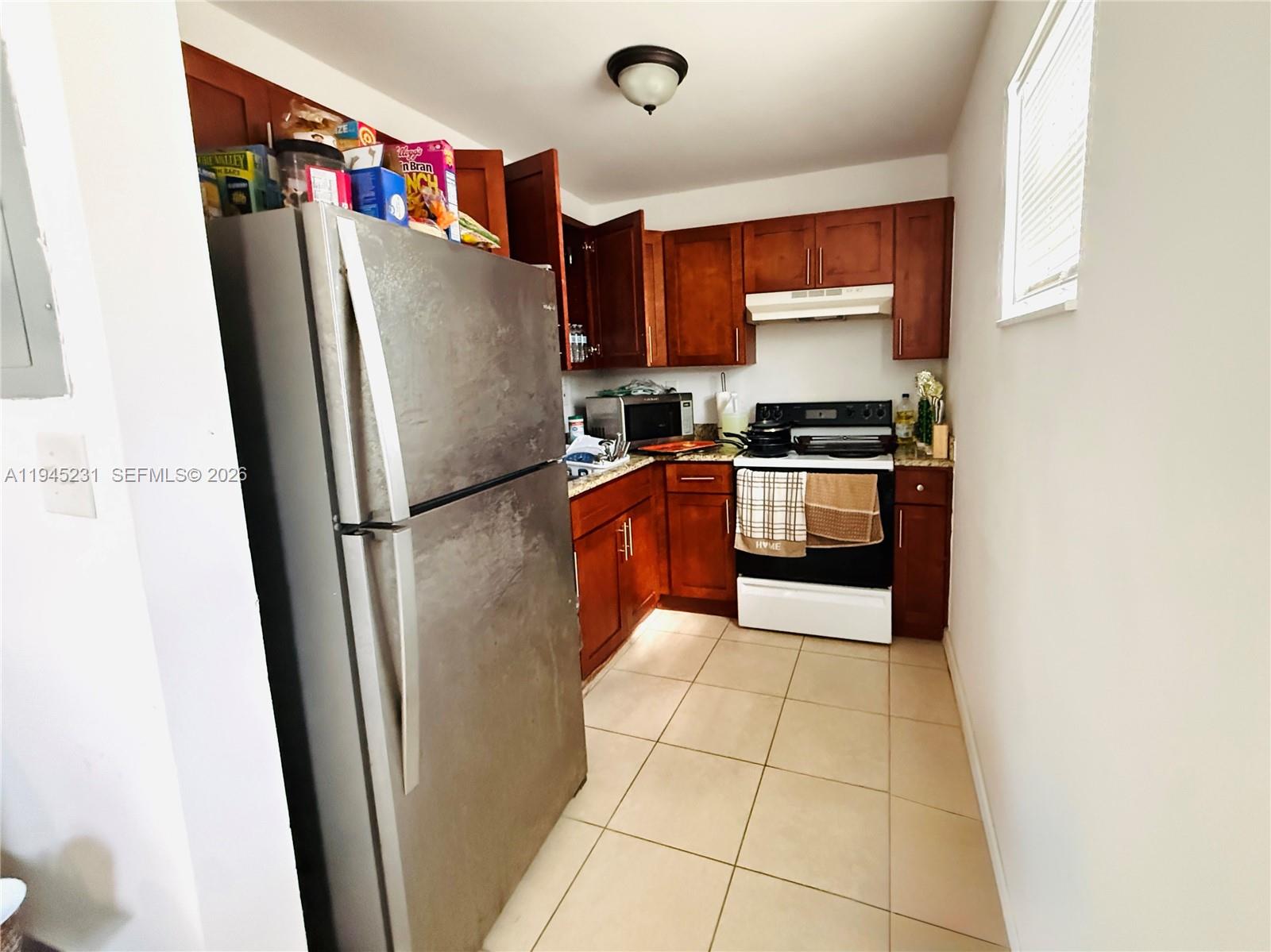 635 Northwest 22nd Road Fort Lauderdale, FL 33311 - Photo 20 of 20 a kitchen with stainless steel appliances granite countertop a refrigerator a stove and a sink