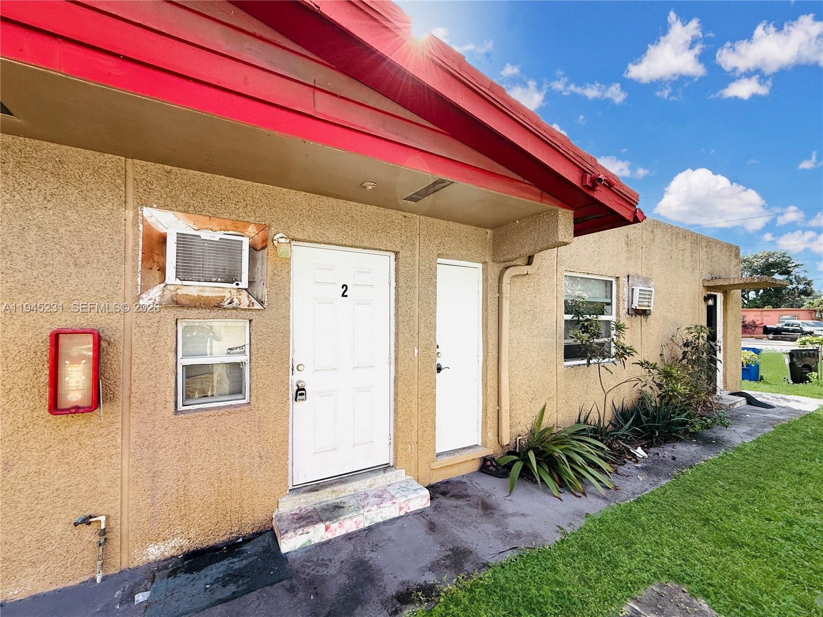 635 Northwest 22nd Road Fort Lauderdale, FL 33311 - Photo 3 of 20 a front view of a house with a yard