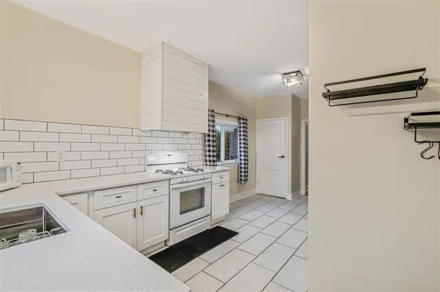 a kitchen with a stove and a refrigerator