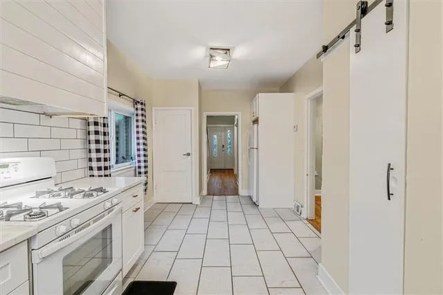 a view of a kitchen with a sink and a refrigerator