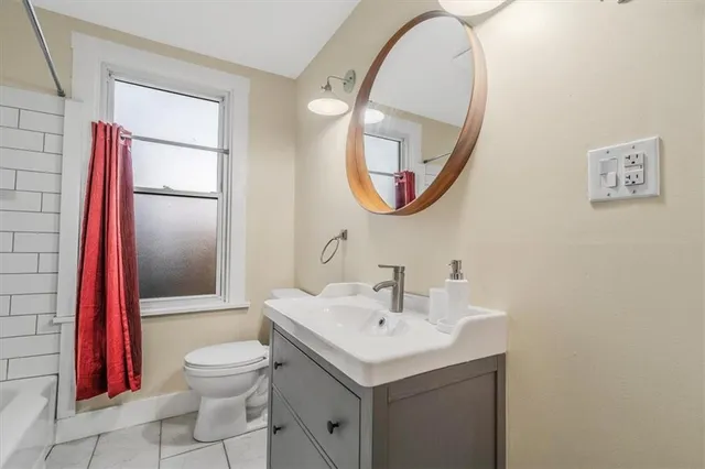 a view of empty room with wooden ceiling