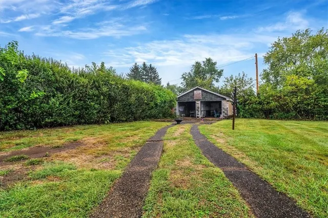a front view of a house with a big yard