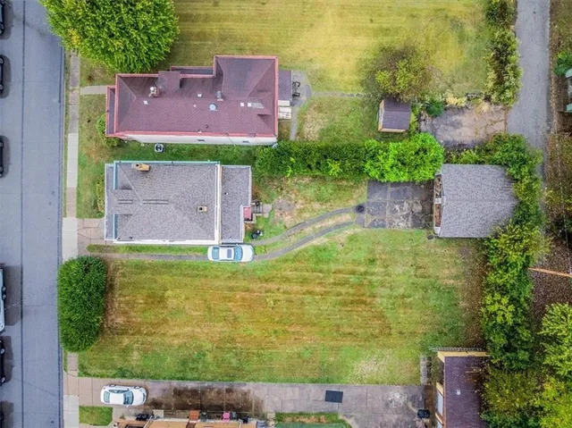 a aerial view of a house with a yard