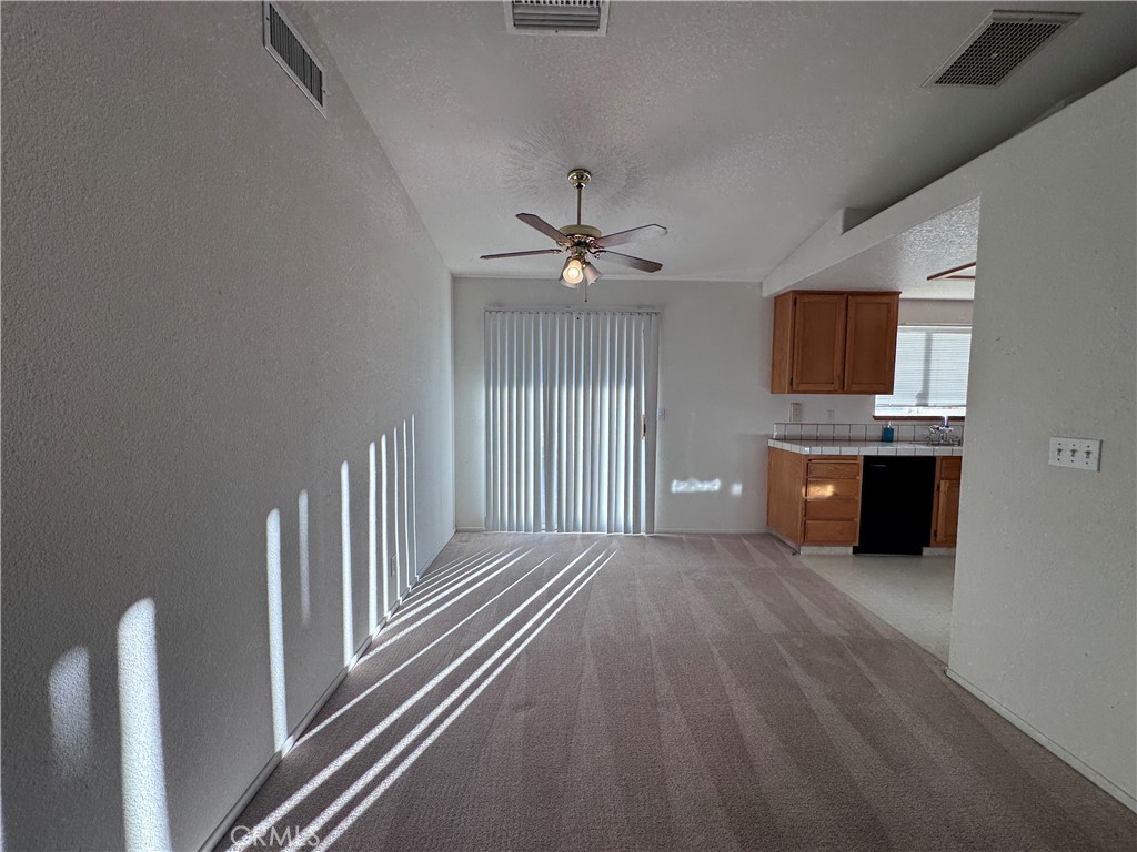 400 Vista Street Ridgecrest, CA 93555 - Photo 13 of 32 a view of an empty room with a fireplace and a window