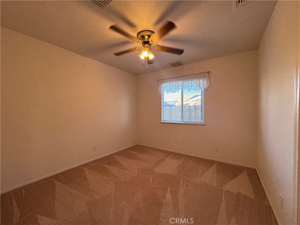 400 Vista Street Ridgecrest, CA 93555 - Photo 23 of 32 an empty room with windows and fan
