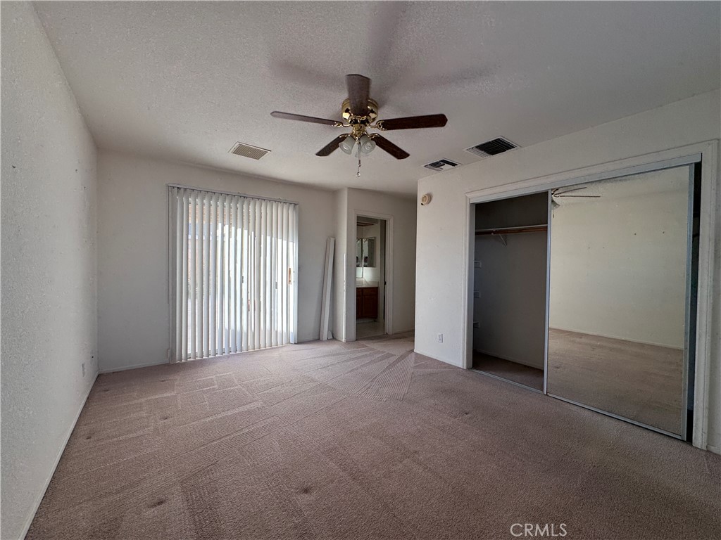 400 Vista Street Ridgecrest, CA 93555 - Photo 25 of 32 an empty room with chandelier fan and windows