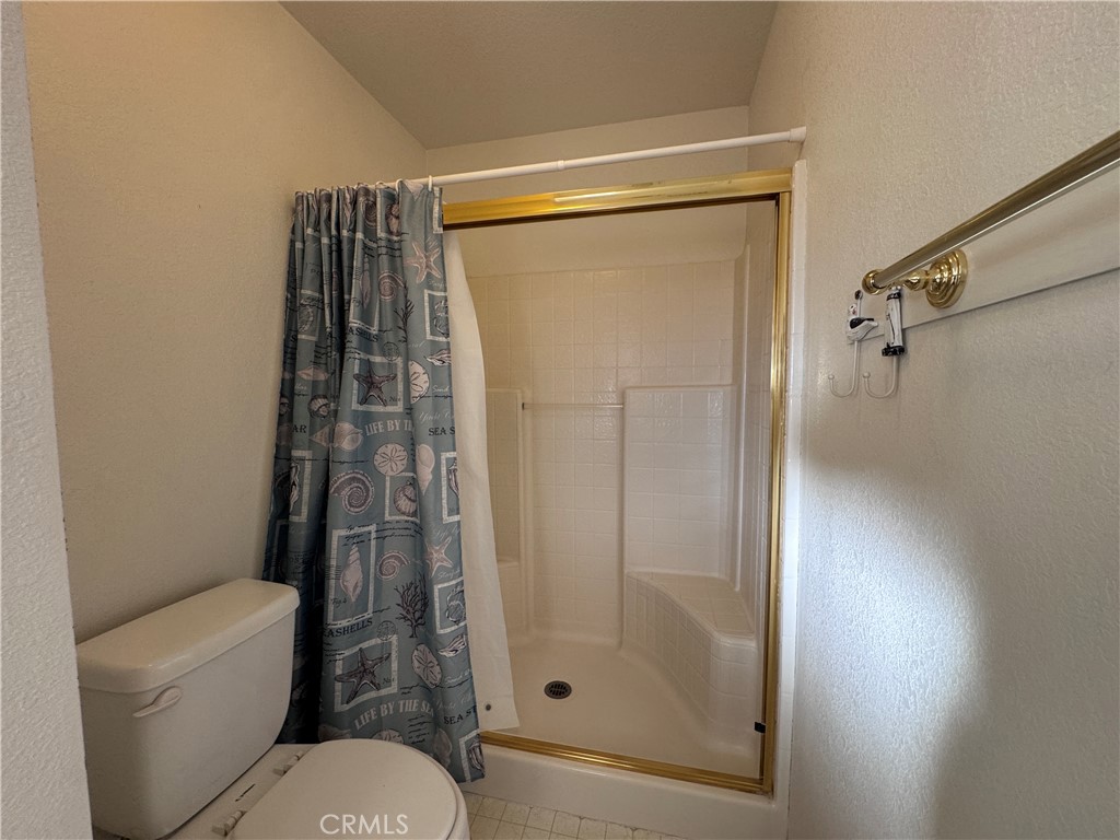 400 Vista Street Ridgecrest, CA 93555 - Photo 28 of 32 a bathroom with a shower and a toilet