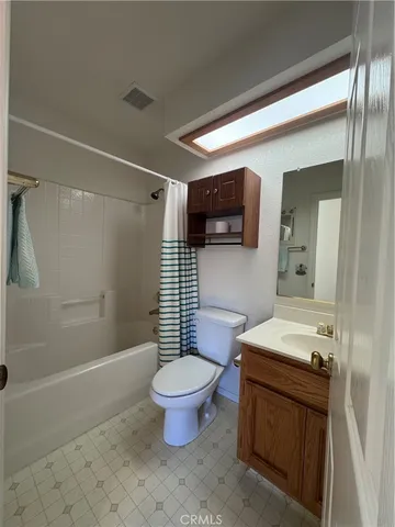 a bathroom with 2 sink tub and a mirror