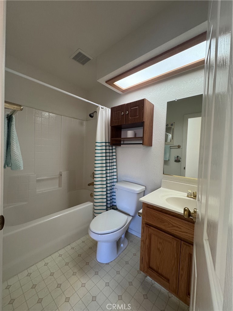 400 Vista Street Ridgecrest, CA 93555 - Photo 29 of 32 a bathroom with a sink toilet a mirror and shower