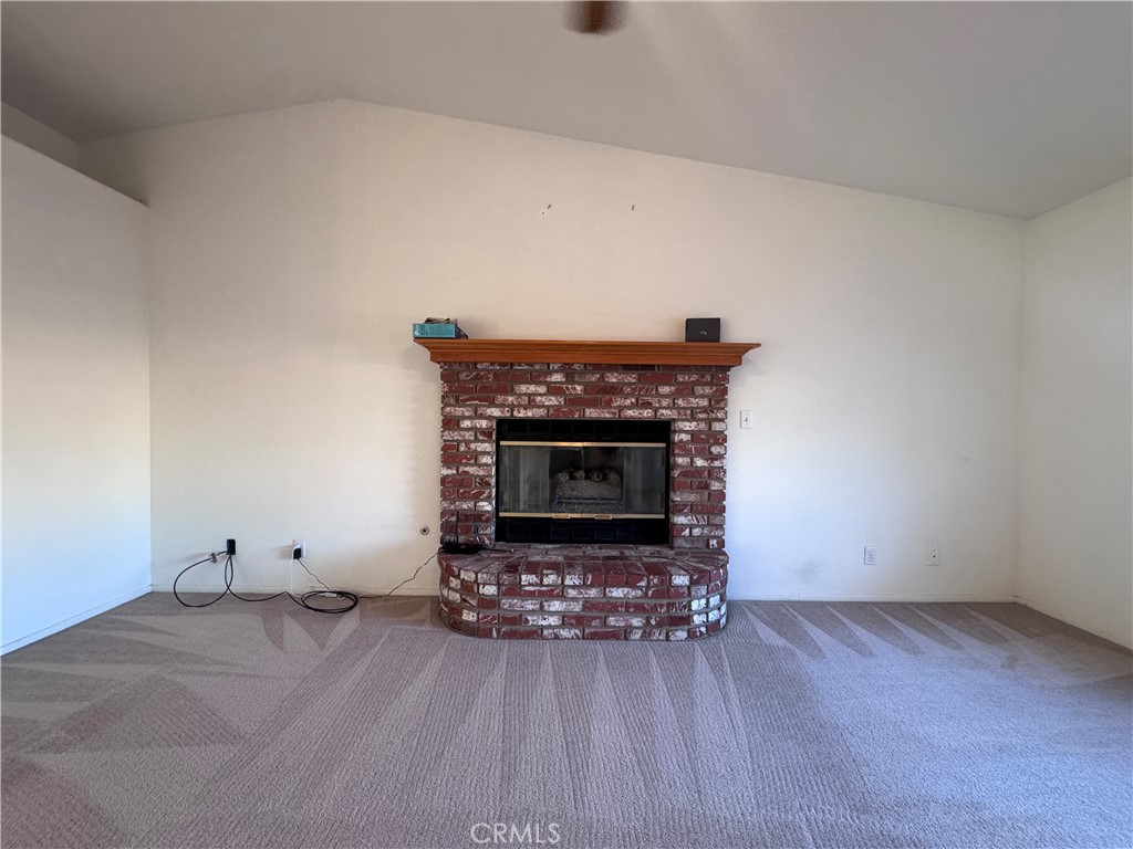 400 Vista Street Ridgecrest, CA 93555 - Photo 10 of 32 a living room with furniture and a fireplace