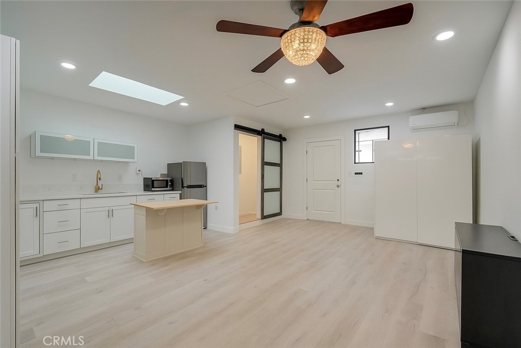 a view of kitchen with center island and stainless steel appliances