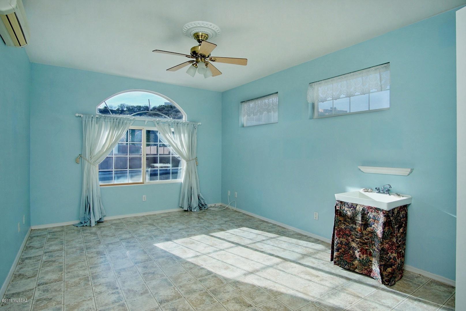 1137 Avenida Seville Rio Rico, AZ 85648 - Photo 7 of 19 a view of livingroom with window ceiling fan and windows
