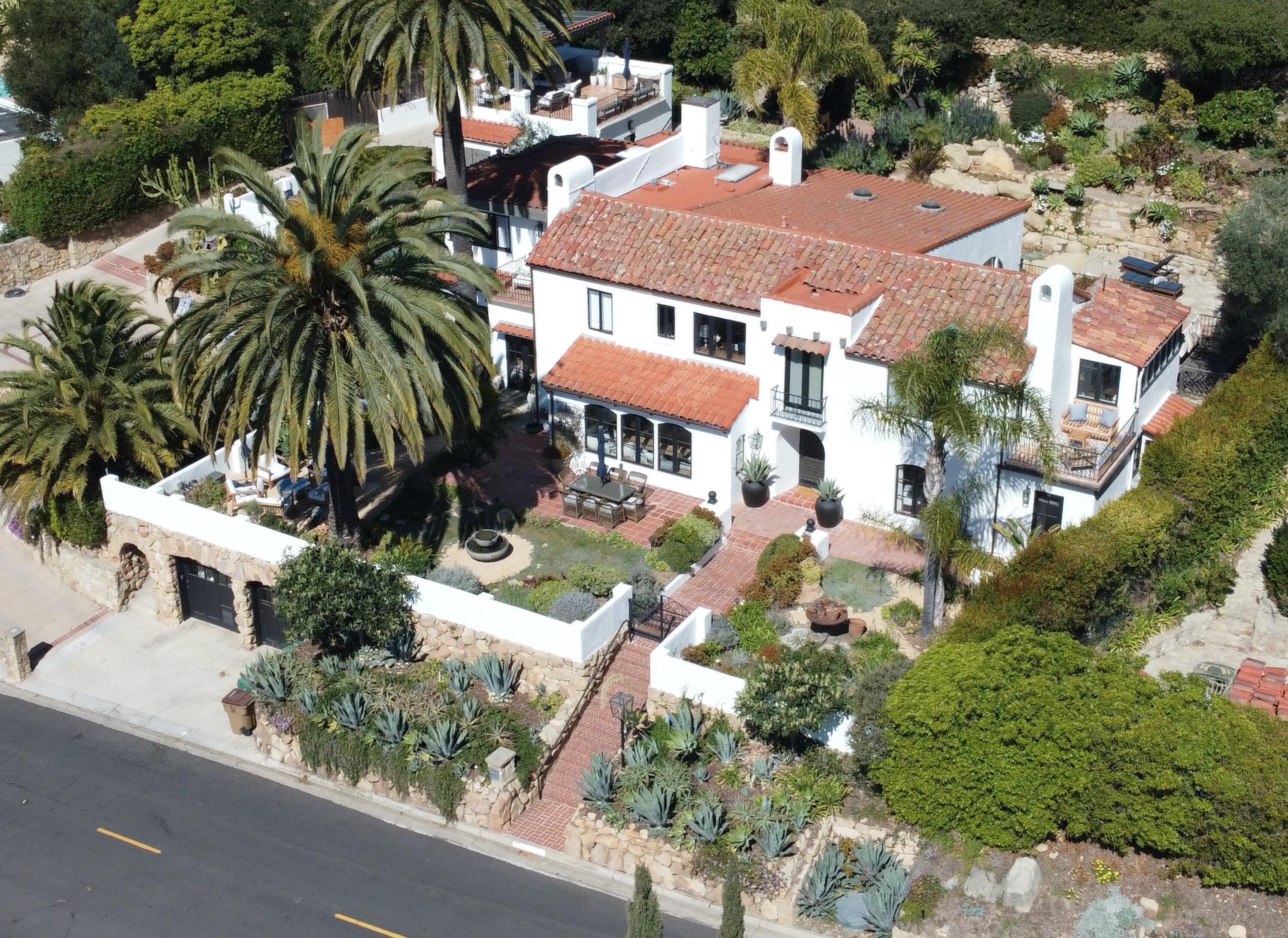an aerial view of multiple houses with yard
