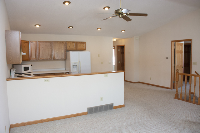 15479 Henry Road, Unit B Morrison, IL 61270 - Photo 10 of 18 a view of kitchen and kitchen with stainless steel appliances wooden floor