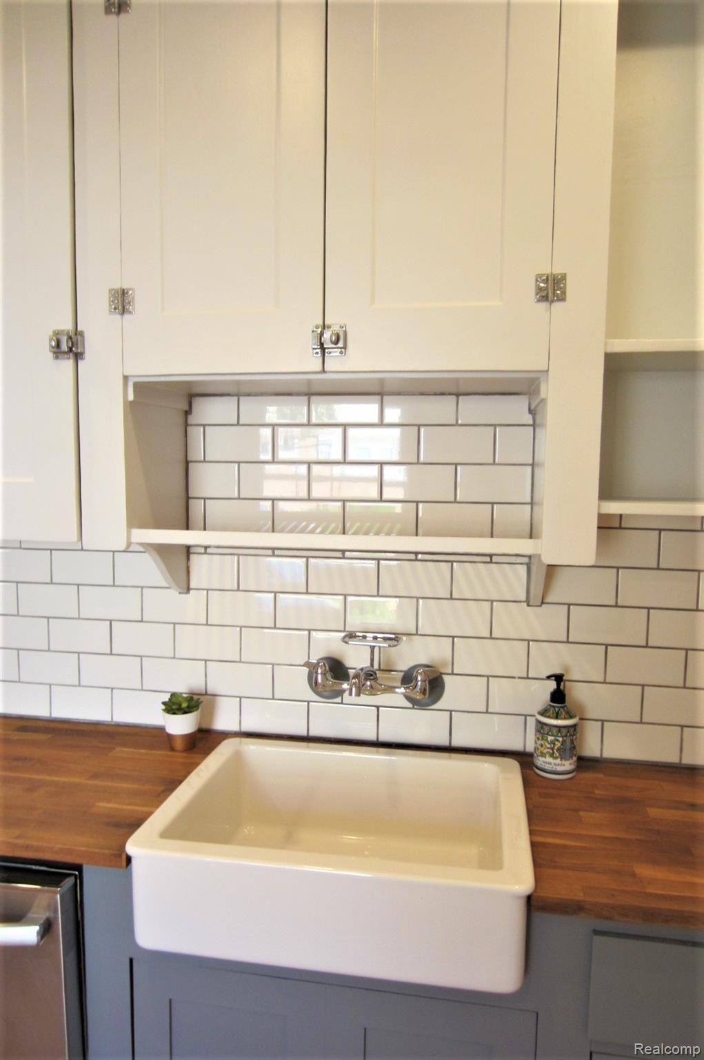 127 Ogemaw Road Pontiac, MI 48341 - Photo 11 of 30 1927 charm is still as special in 2021! Newer ceramic subway tile backsplash and butcher block counter.