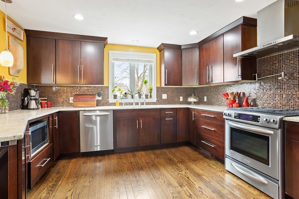 114 River Street Hudson, MA 01749 - Photo 11 of 40 a kitchen with a sink stove and cabinets