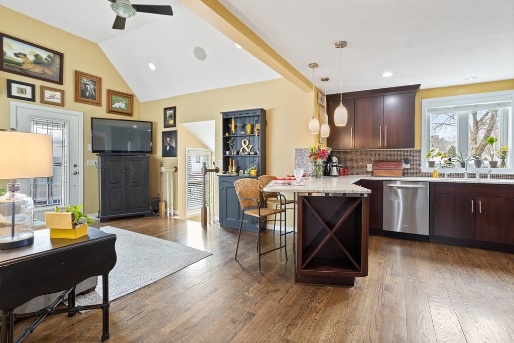 114 River Street Hudson, MA 01749 - Photo 13 of 40 a living room with stainless steel appliances kitchen island granite countertop wooden floors and a view of kitchen