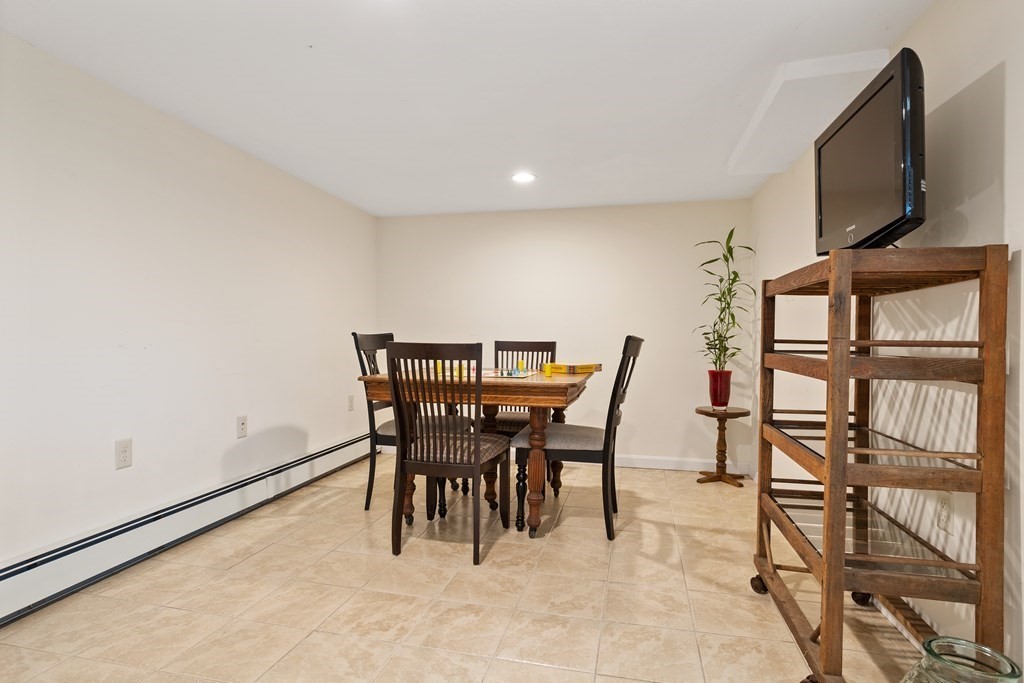 114 River Street Hudson, MA 01749 - Photo 17 of 40 a view of a dining room with furniture and a flat screen tv