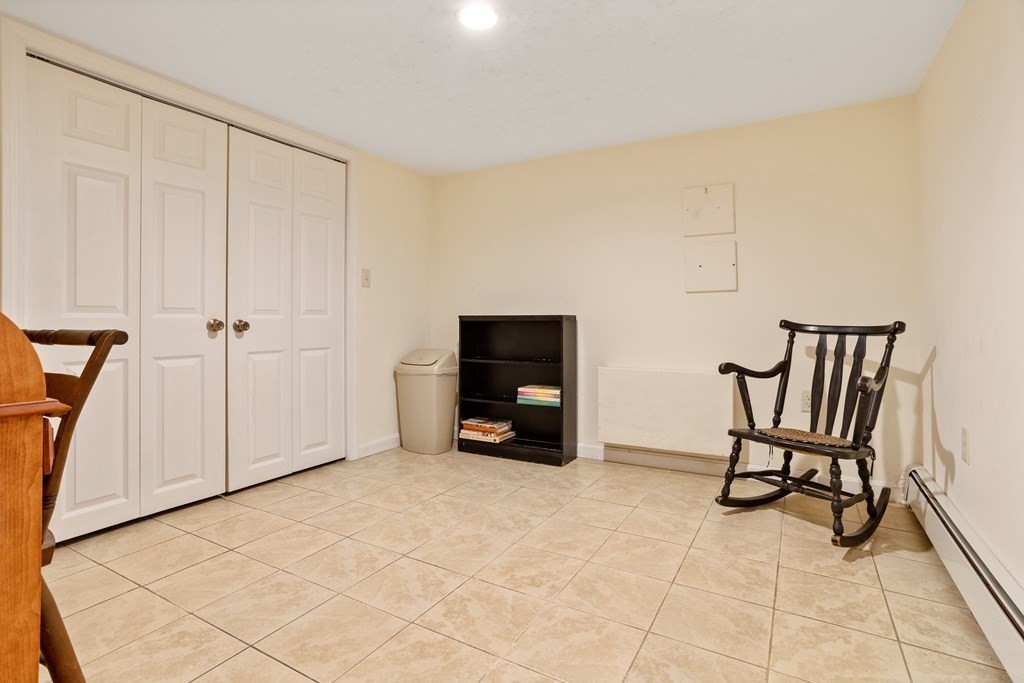 114 River Street Hudson, MA 01749 - Photo 19 of 40 a view of an empty room with furniture and a fireplace