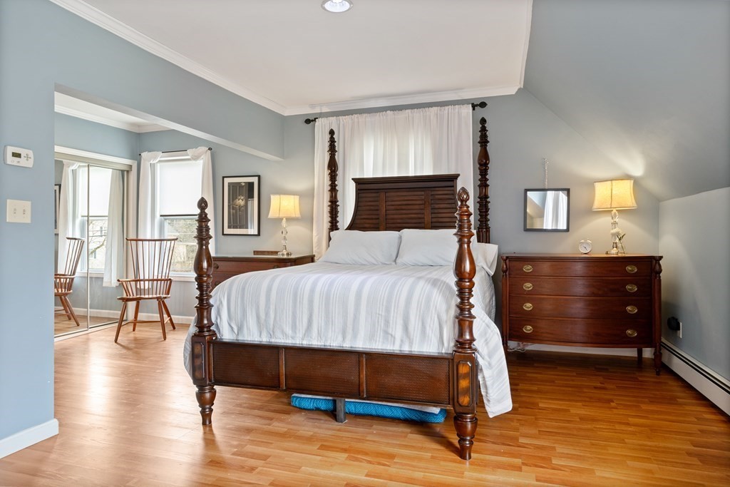 114 River Street Hudson, MA 01749 - Photo 22 of 40 a bedroom with a bed a table and painting on the wall