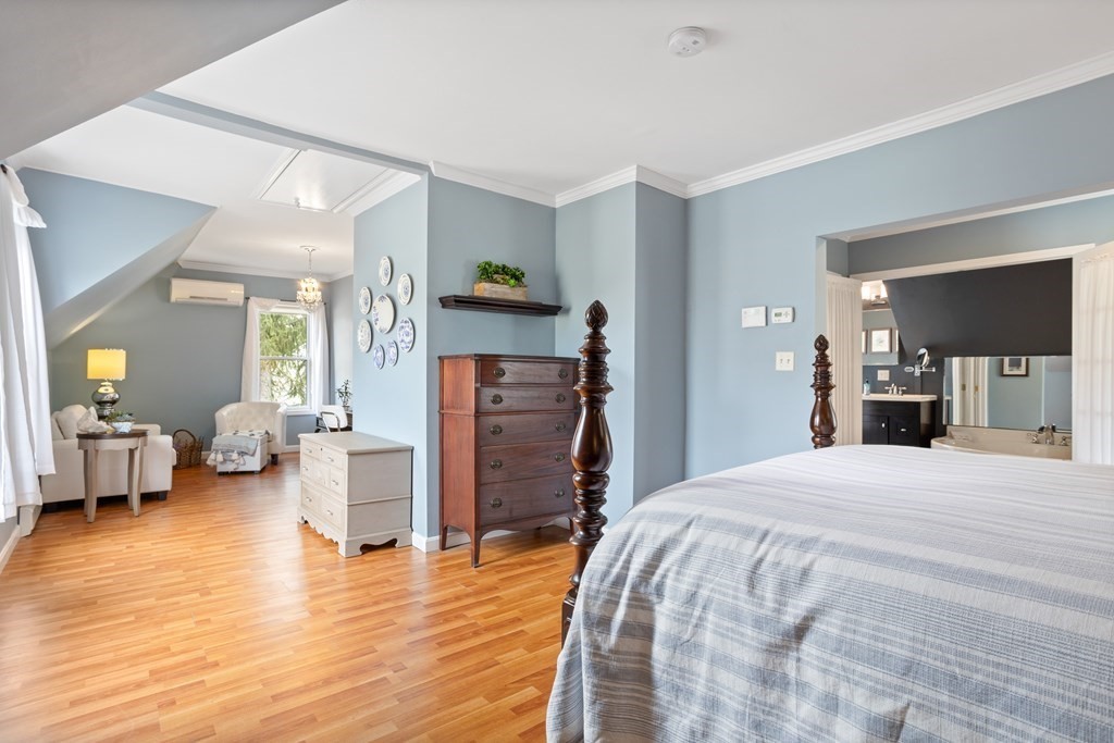 114 River Street Hudson, MA 01749 - Photo 23 of 40 a bedroom with a bed and wooden floor