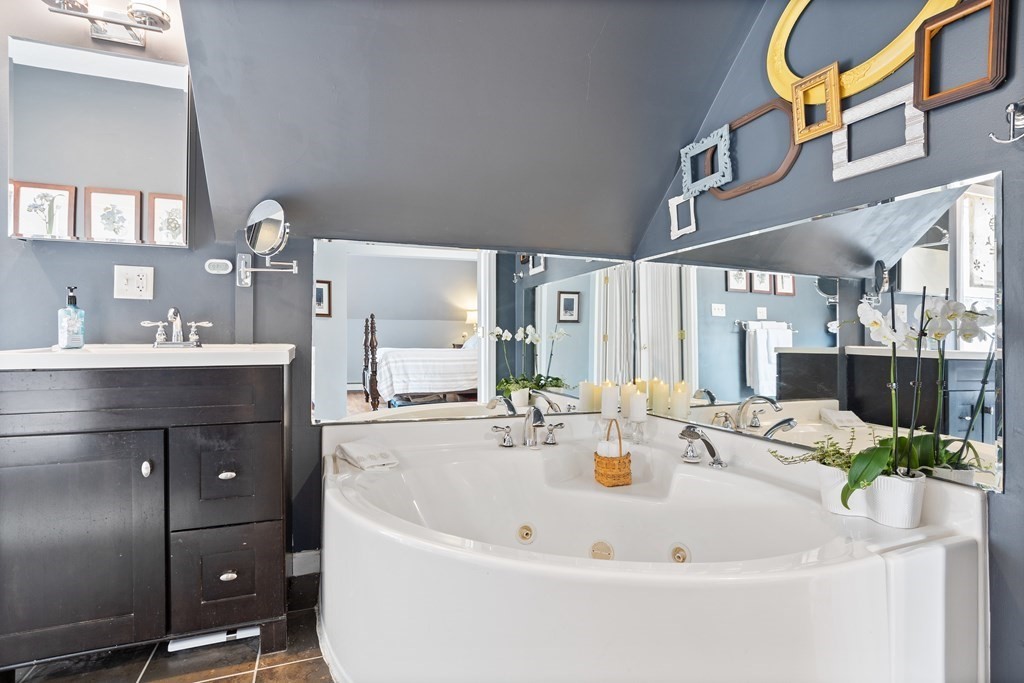 114 River Street Hudson, MA 01749 - Photo 25 of 40 a bathroom with a tub sink and mirror