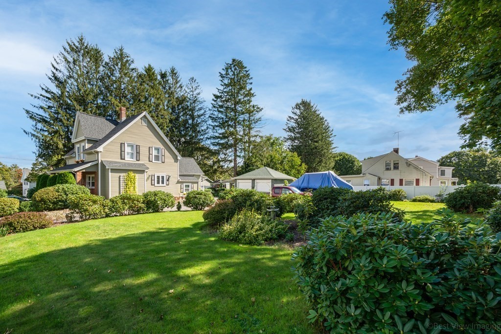 114 River Street Hudson, MA 01749 - Photo 27 of 40 a front view of a house with a yard and garage