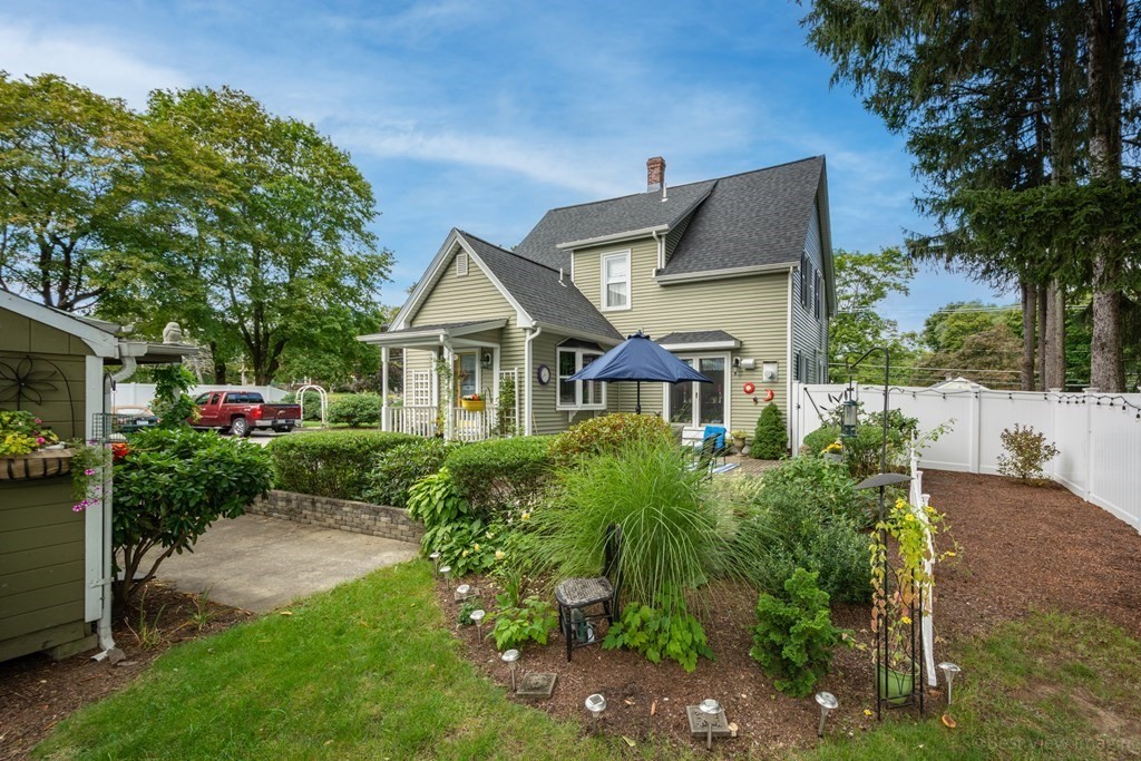 114 River Street Hudson, MA 01749 - Photo 28 of 40 a front view of a house with a garden
