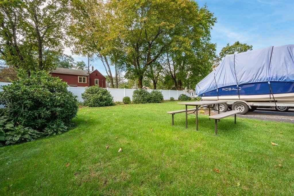 114 River Street Hudson, MA 01749 - Photo 34 of 40 a view of backyard with table and chairs and potted plants