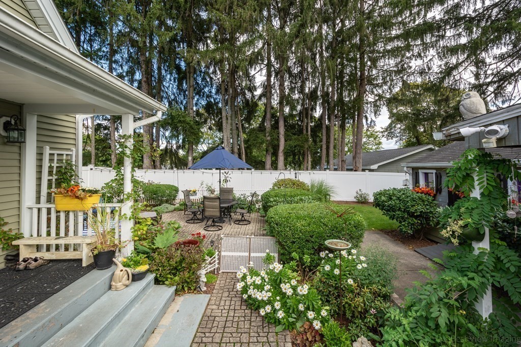 114 River Street Hudson, MA 01749 - Photo 35 of 40 a view of a patio with table and chairs and potted plants