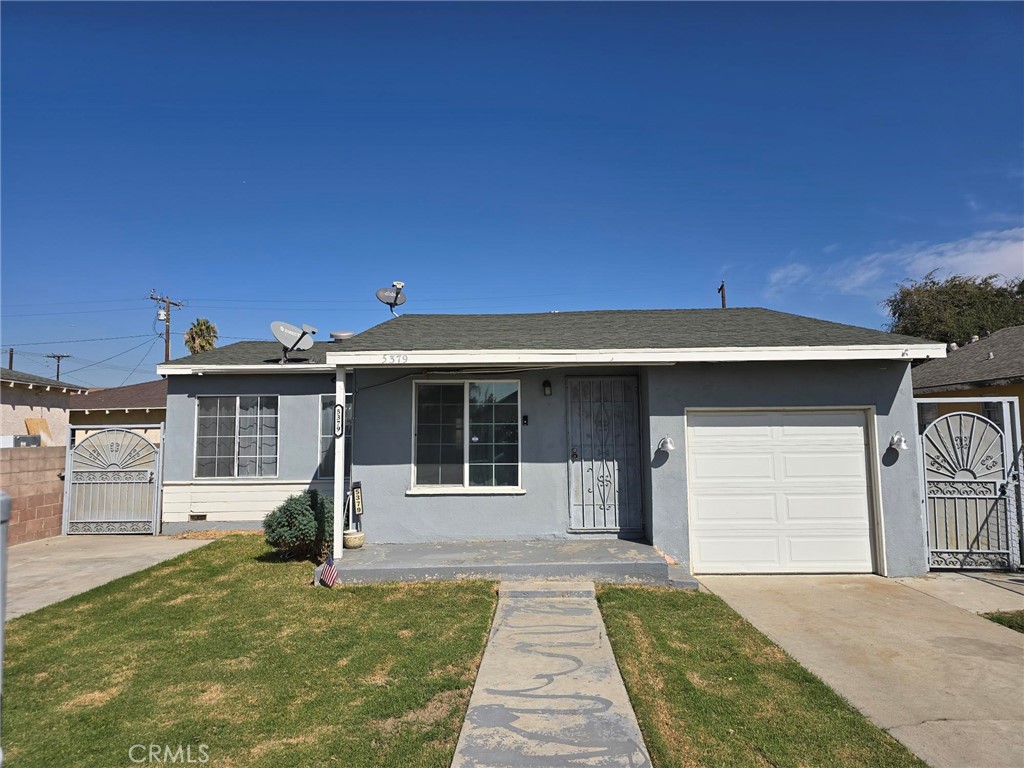 5379 35th Street Riverside, CA 92509 - Photo 3 of 10 a front view of a house with a yard and potted plants