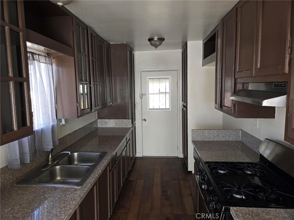 5379 35th Street Riverside, CA 92509 - Photo 7 of 10 a kitchen with granite countertop a sink stove and cabinets